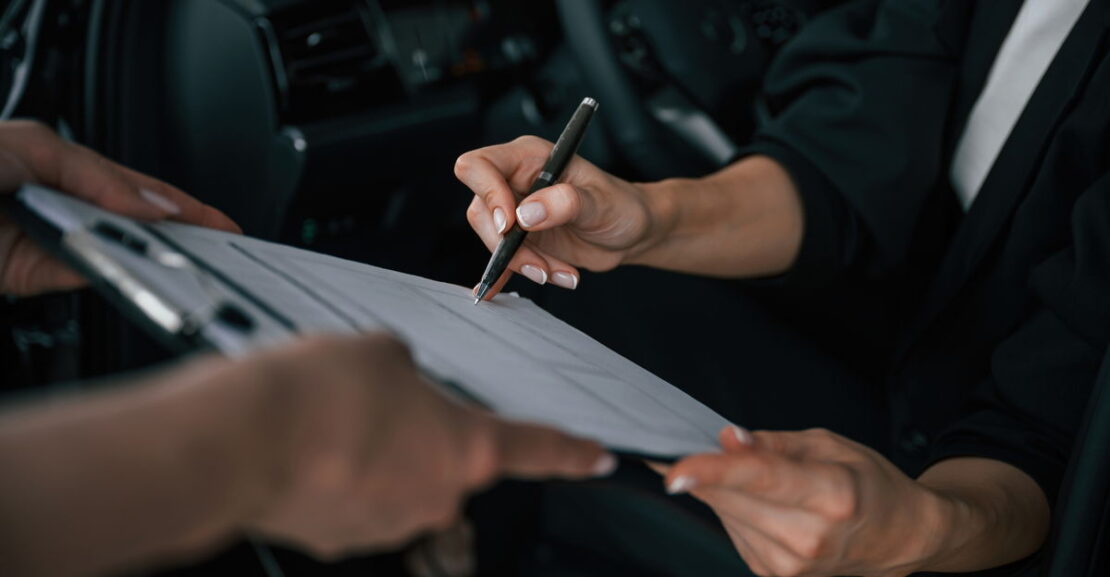 process of buying new car woman is signing docume 2025 03 18 21 32 18 utc 1200L