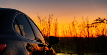 shiny black car with a beautiful sunset at the she 2025 02 08 23 44 19 utc 1200L