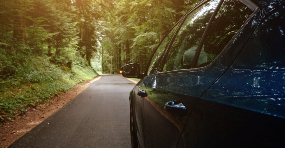 the car on the road with the forest around it 2025 01 16 08 16 23 utc 1200L